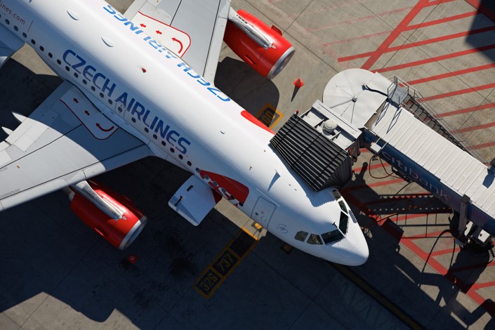 Czech Airlines Airbus A319 aircraft on a stand connected with the terminal building by a jet bridge